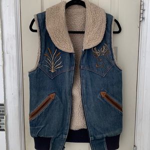 denim vest with patterns on chest pockets